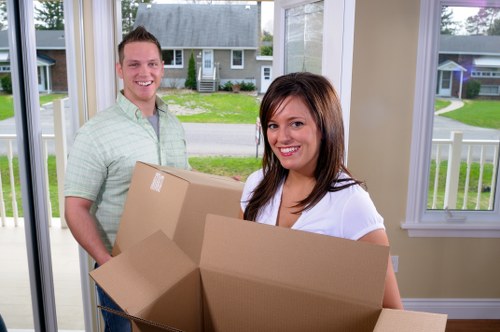 Local movers organising packed items for transport in Enfield