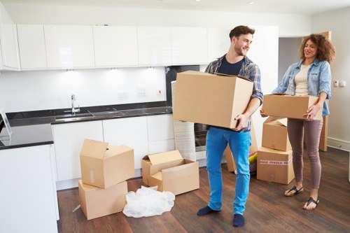 Local moving team loading boxes into a removals van in Enfield