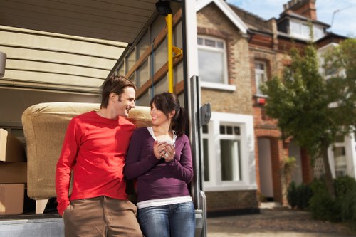 Movers handling furniture carefully in a local Enfield home